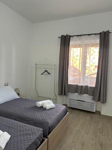 a bedroom with two beds and a window at S'Istella Affittacamere in Tinnura