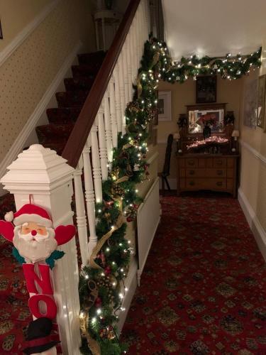 a staircase with a christmas tree and santa claus at Tigh N Eilean Self Catering Aberfeldy in Aberfeldy