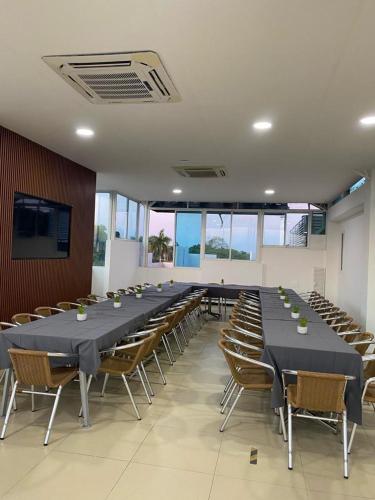 a large conference room with a long table and chairs at Hotel El Potrillo in Puerto López