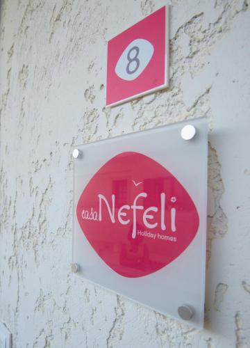 a sign on a wall with the number eight at casa NEFELI in Karteros