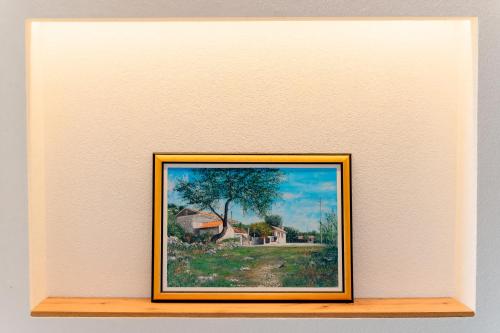 a picture of a painting on a shelf at Guesthouse Papac in Stolac