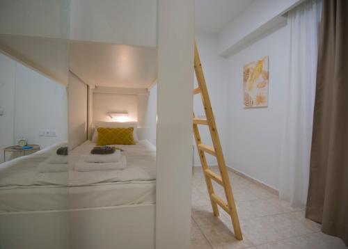 a bedroom with a bunk bed and a ladder at casa NEFELI in Karteros