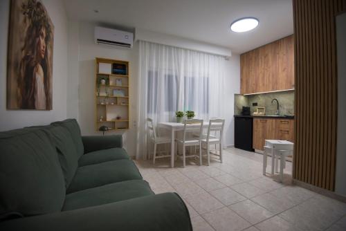 a living room and kitchen with a couch and a table at casa NEFELI in Karteros