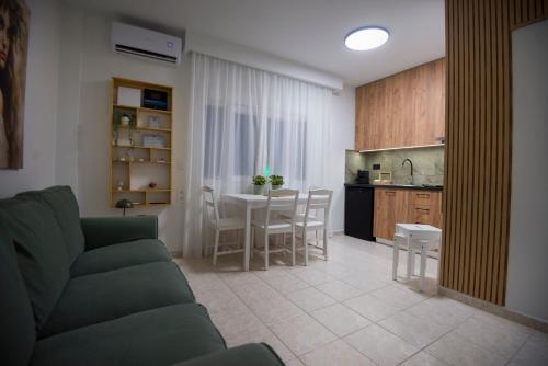 a living room and kitchen with a couch and a table at casa NEFELI in Karteros