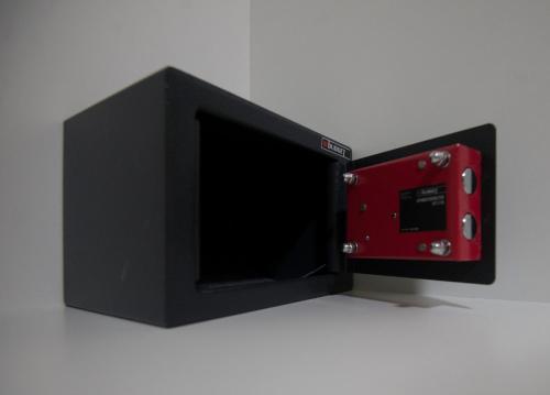 a small black and red microwave oven sitting on a counter at casa NEFELI in Karteros