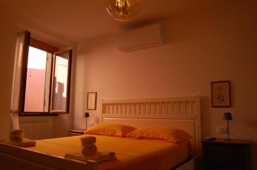 a bedroom with a bed with two pillows and a window at Palazzina Storica al Mare, Rapallo in Rapallo