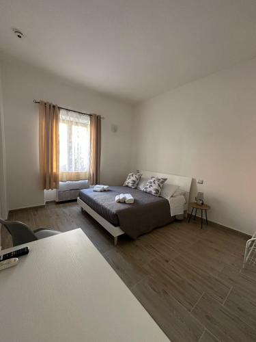 a bedroom with a bed and a large window at S'Istella Affittacamere in Tinnura