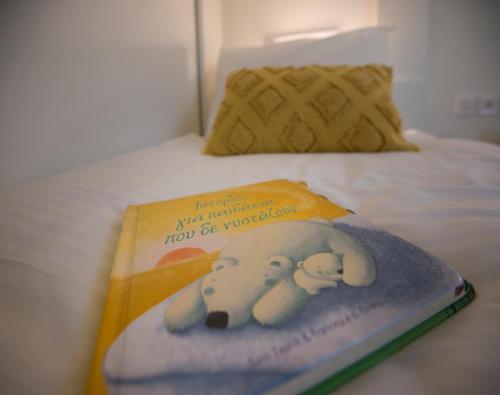 a book with an elephant on it sitting on a bed at casa NEFELI in Karteros