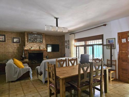 a living room with a table and a dining room at Casa Rural RosaVera in Ossa de Montiel