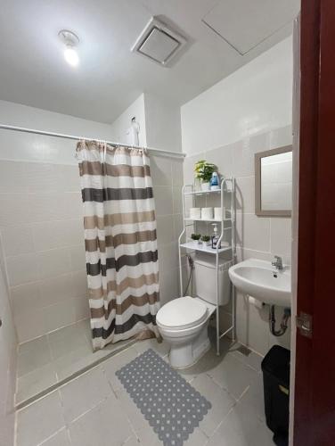 a bathroom with a toilet and a sink at Hailey's Place in Bacolod