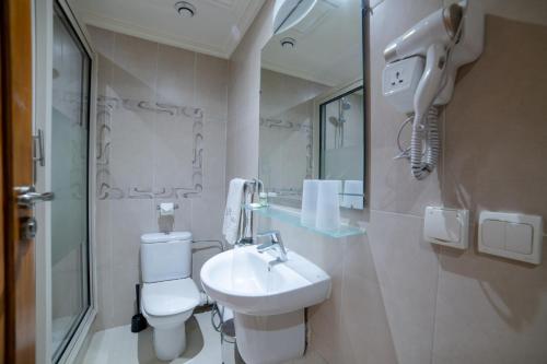 a bathroom with a white toilet and a sink at Hotel Palais Al Bahja in Marrakech