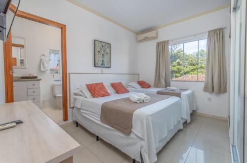 una camera da letto con un letto grande e una finestra di Pousada Villa D'Ouro a Penha