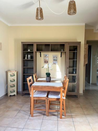 a dining room with a wooden table and chairs at Appartamento Ortensia Lucca in Capannori