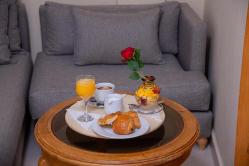 a coffee table with a tray of food and orange juice at Hotel Palais Al Bahja in Marrakech