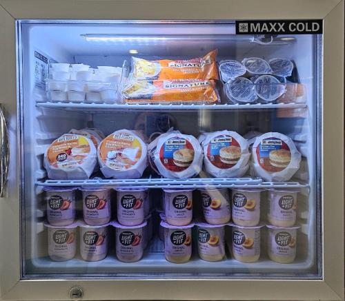 a refrigerator filled with eggs and other food items at Microtel Inn & Suites by Wyndham Austin Airport in Austin