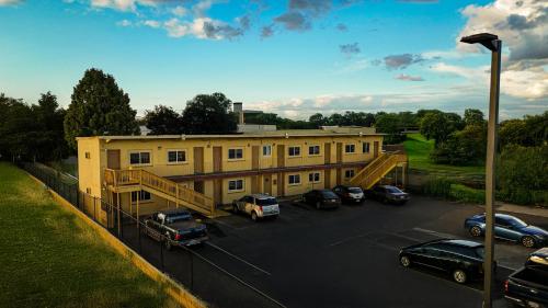 a large building with cars parked in a parking lot at Travel Inn in Sunnyside