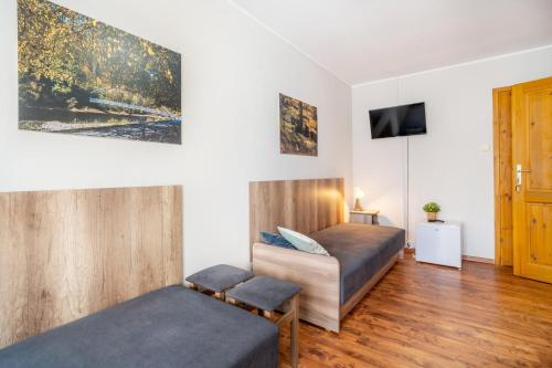 a bedroom with two beds and a tv at 4 Pory Roku - Węgierska Górka in Węgierska Górka