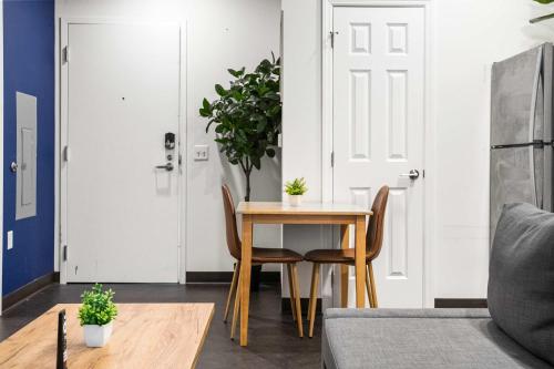 a dining room with a table and chairs and a door at CozySuites Gorgeous 1BR in Downtown Pitts #13 in Pittsburgh