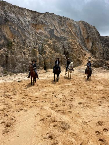 a group of people riding horses in the desert at Villa Rebequita in Villapinzón
