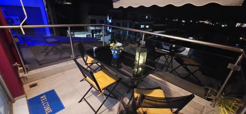 a view of a balcony with a table and chairs at Perfect Suites in Neos Marmaras