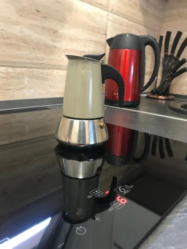a coffee maker sitting on top of a stove at Annabella Vendégház in Hajdúszoboszló