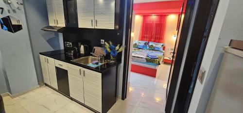 a small kitchen with a sink and a bathroom at Perfect Suites in Neos Marmaras