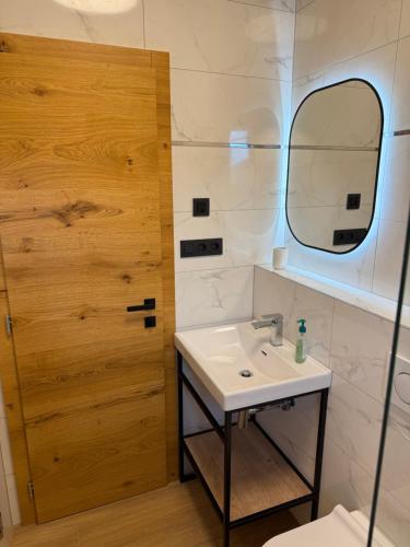 a bathroom with a sink and a mirror at Apartmán Hrabušice G3 - Slovenský Raj in Hrabušice