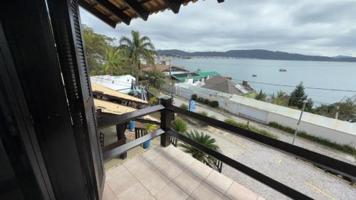 a view of the ocean from a house balcony at Pousada Caminho do Mar in Bombinhas