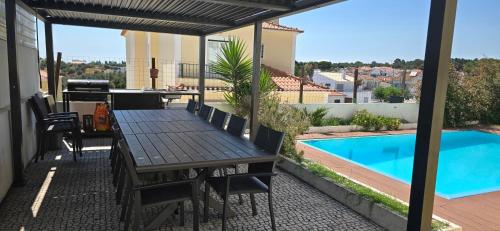 a patio with a table and a swimming pool at Alentejo`s Nest in Alcácer do Sal