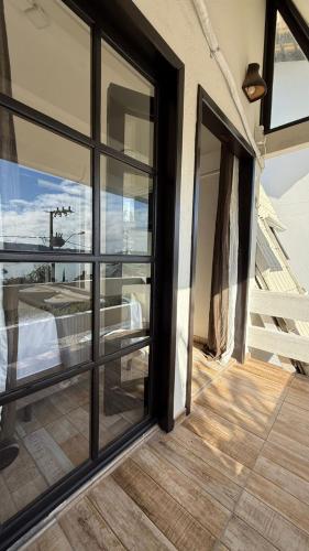 an open glass door to a balcony with a view at Pousada Caminho do Mar in Bombinhas