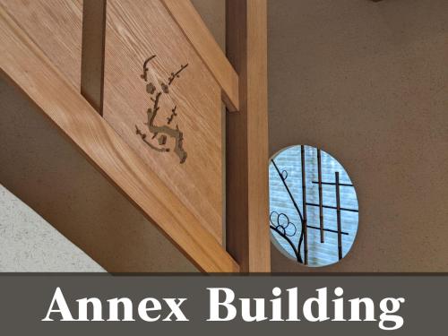 a wood door with a window with an angel building on it at 越前の宿うおたけ in Echizen-shi