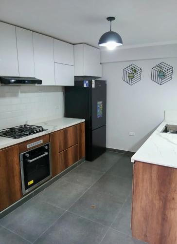 an empty kitchen with a stove and a refrigerator at Misha House in Huaraz