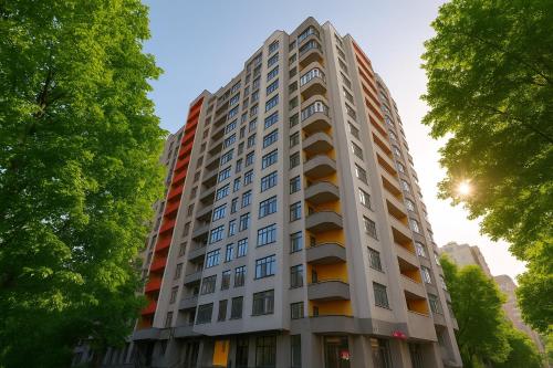 a tall white building with trees in front of it at New Business-Class Apartment 1 хв від метро in Kyiv