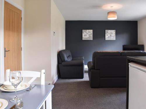 a living room with a couch and a chair at One Dorchester Drive - Uk32037 in Inglewhite