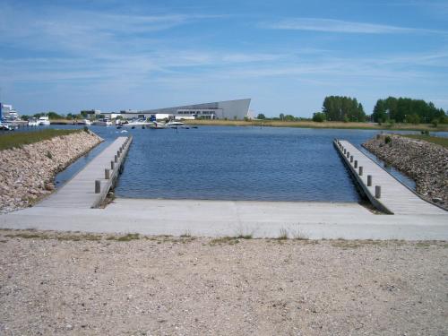 a large body of water with a dock at Tangloppen Camping & Cottages in Ishøj
