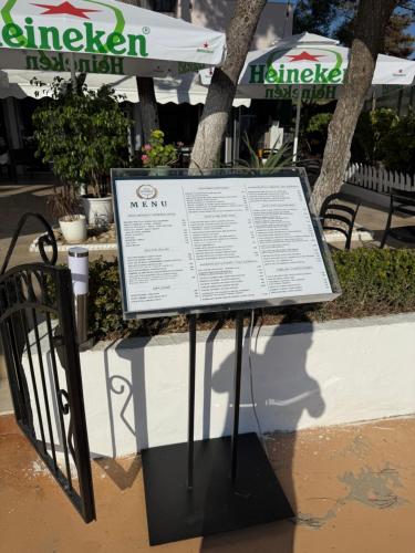 a sign sitting on the side of a sidewalk at VILA Daniele in Durrës