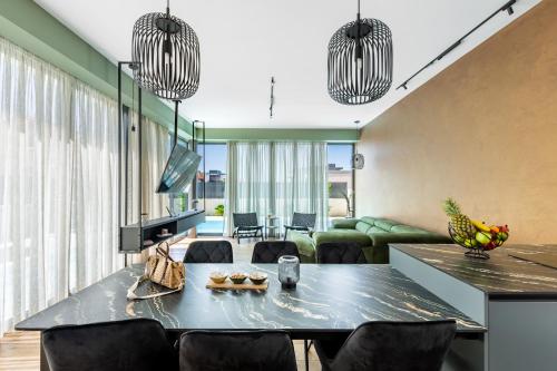 a living room with a table and some chairs at Villa Restart Vrsi-Mulo in Vrsi