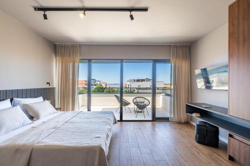 a bedroom with a large bed and a balcony at Villa Restart Vrsi-Mulo in Vrsi