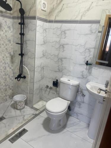 a bathroom with a toilet and a shower and a sink at Riad Ajdir Al Hoceima in Andalouciene