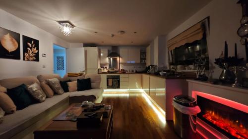 a living room with a couch and a fire place at The Bridge in Dartford