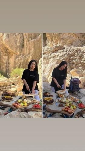a woman sitting at a picnic table with food at Dana Gardens Hotel in Dana