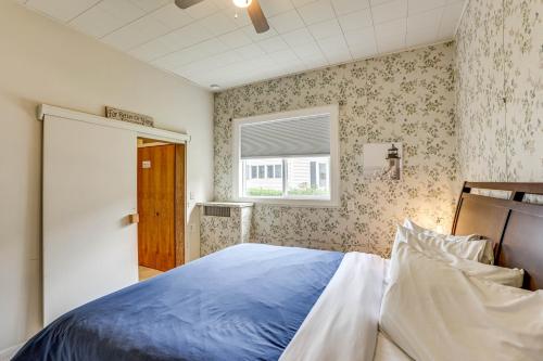 a bedroom with a blue bed and a window at Walk to Lake Michigan and Dtwn Coastal Grand in Ludington