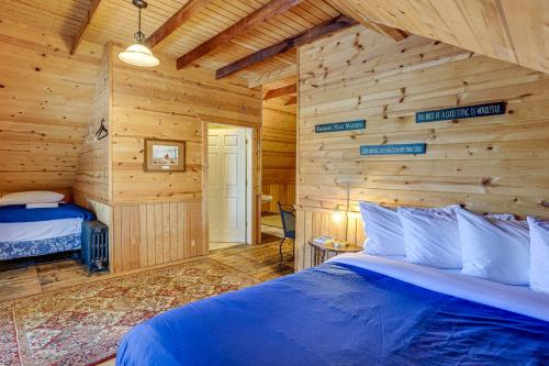 a bedroom with a bed in a log cabin at Walk to Lake Michigan and Dtwn Coastal Grand in Ludington