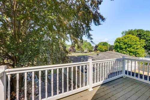 a balcony with a white railing and trees at Walk to Lake Michigan and Dtwn Coastal Grand in Ludington