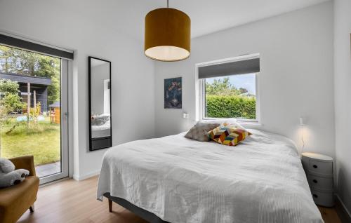 a bedroom with a bed and a large window at Beautiful Home In Fårevejle With Wifi in Fårevejle