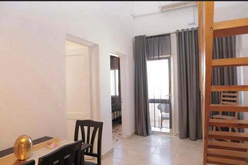 a living room with a table and chairs and a dining room at Cecilia Resort in Hurghada