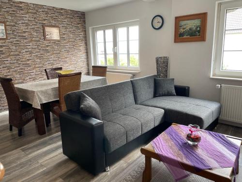a living room with a couch and a table at Ferienwohnung Amöneburg In Amöneburg in Amöneburg