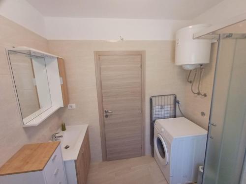 a bathroom with a washing machine and a washer at Apartman Aurora Salakovci in Labin