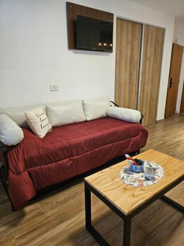 a living room with a red couch and a coffee table at Cómodo y moderno departamento en Buenos Aires in Buenos Aires