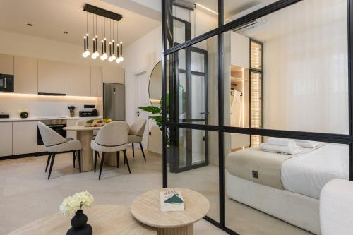 a bedroom and living room with a bed and a table at Sentio Thassos Suites in Limenas